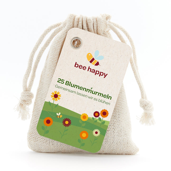 Leinenbeutel mit Etikett "bee happy", 25 Blumenmurmeln, Illustration von Blumen und einer Biene.