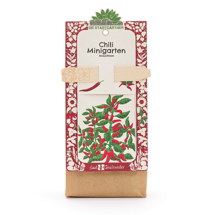 Chili Minigarten Anzuchtset von Die Stadtgärtner mit rotem und grünem Pflanzenmotiv auf der Verpackung.